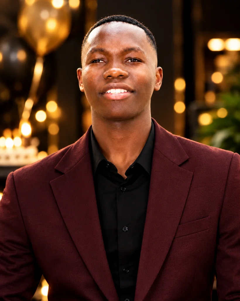 Burgundy tailored suit celebration portrait with warm event lighting